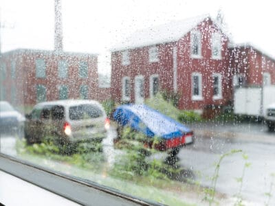 Rainy window with house in background.